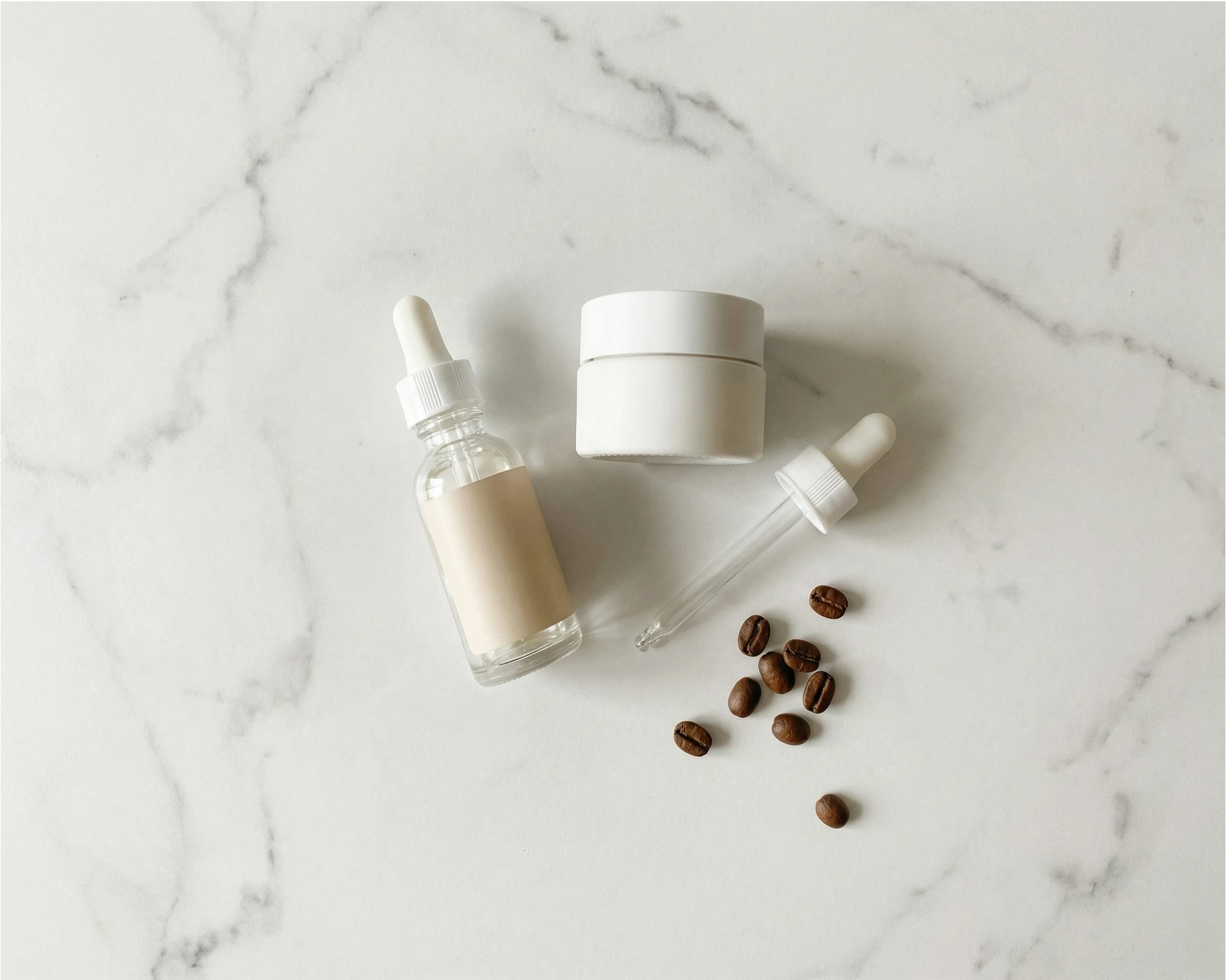 caffeine eye cream serum flat lay with coffee beans